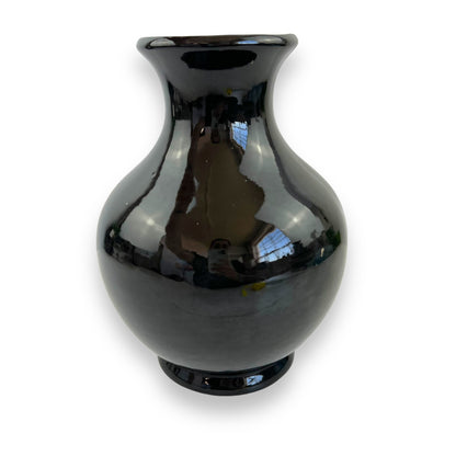 Large black vase with white and yellow flower artwork