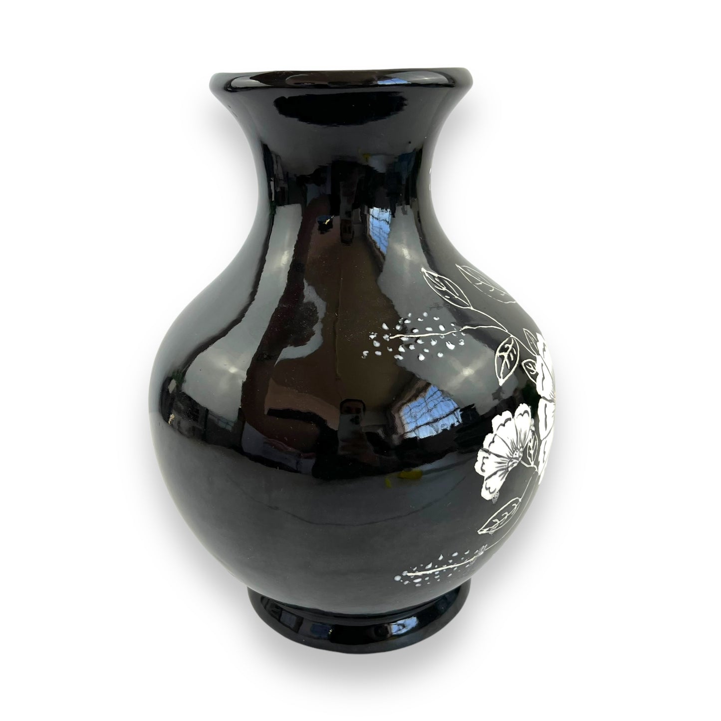 Large black vase with white and yellow flower artwork