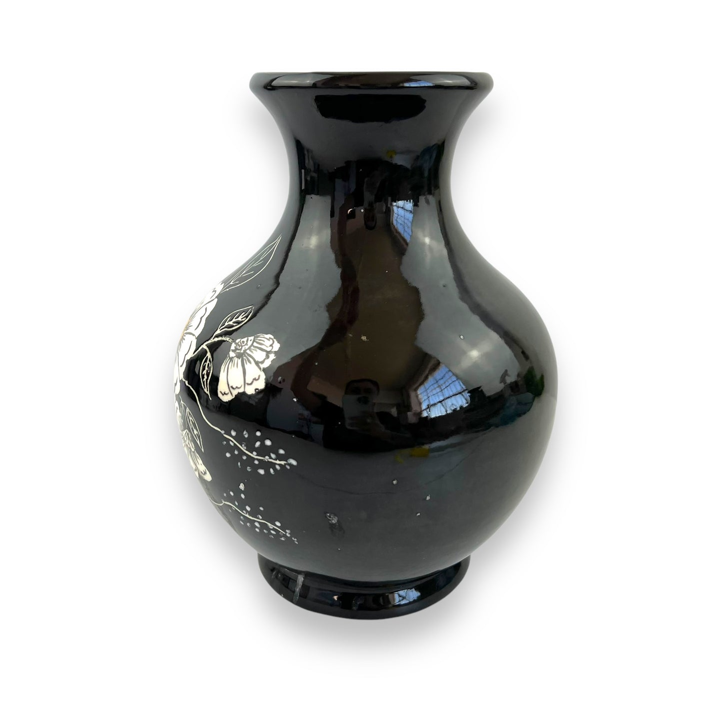 Large black vase with white and yellow flower artwork