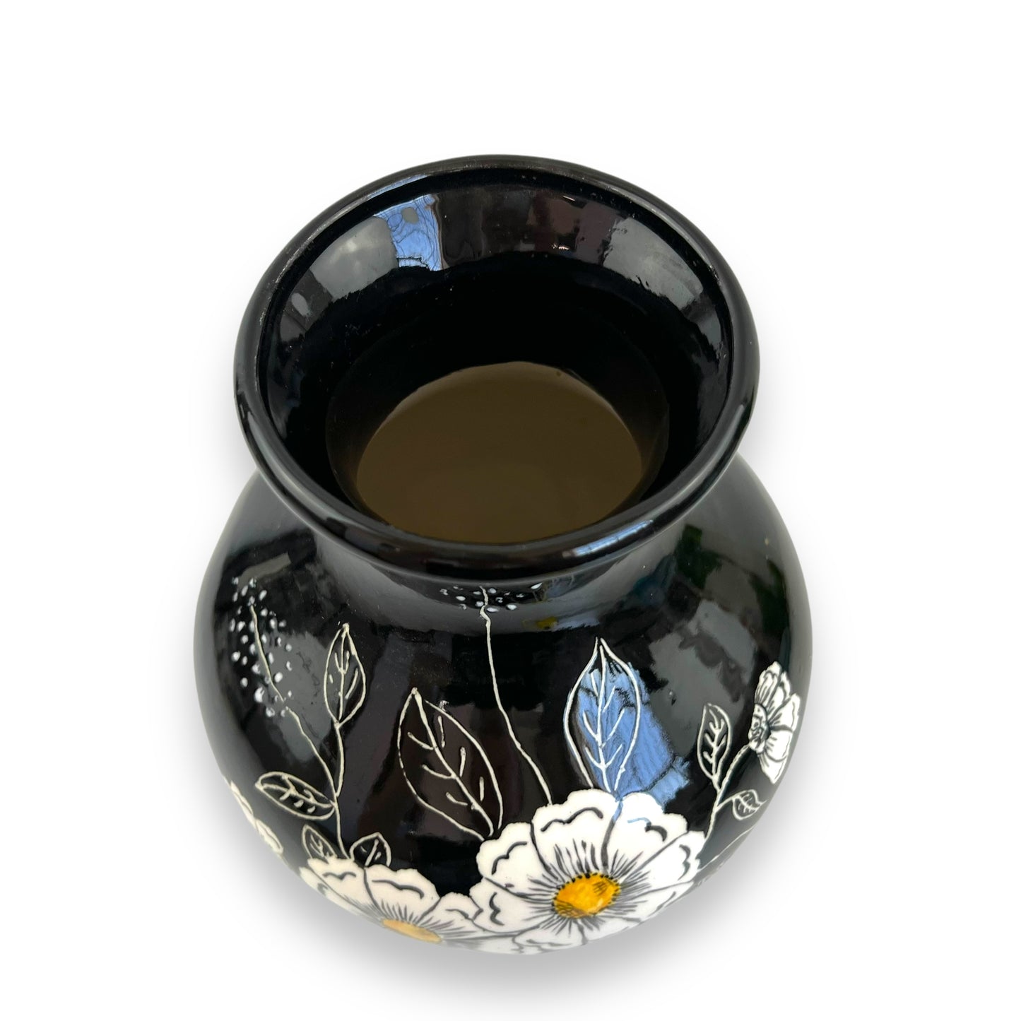 Large black vase with white and yellow flower artwork